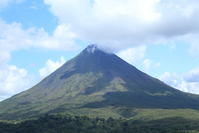 The cone of Arenal Volcano above forest in Arenal Volcano National Park